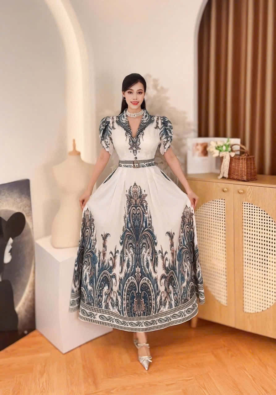 Elegant Vietnamese Baroque maxi dress in mango silk with puff sleeves, perfect for formal wear.