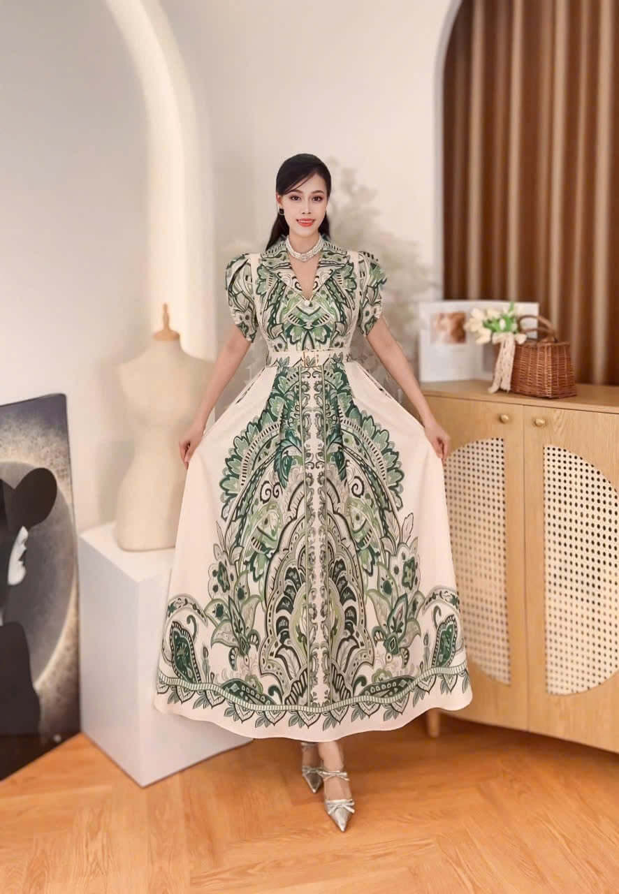Vietnamese Baroque maxi dress mango silk featuring intricate green patterns and elegant design, worn by a model.